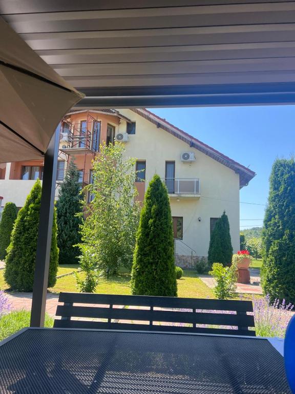 a view from the patio of a house with a bench at Pensiunea Koruna in Poenari