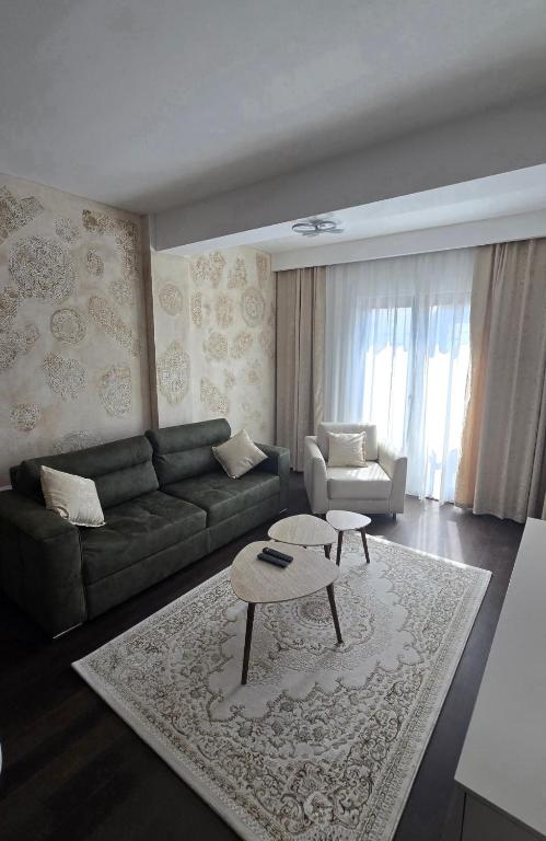 a living room with a couch and a coffee table at Stan apartman Kolašin in Kolašin