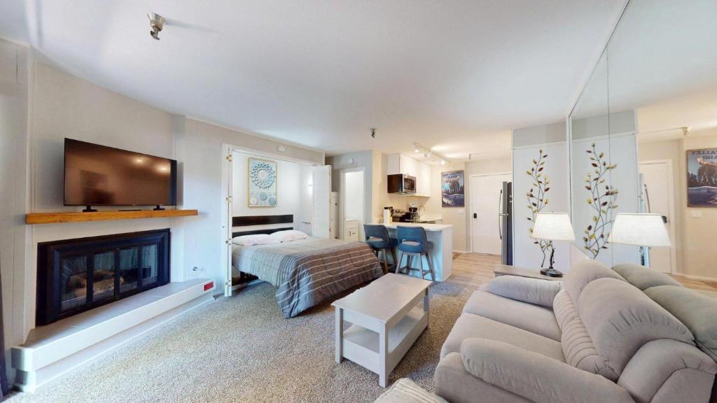 a living room with a couch and a fireplace at Elkhorn Village Studio 2026 in Sun Valley