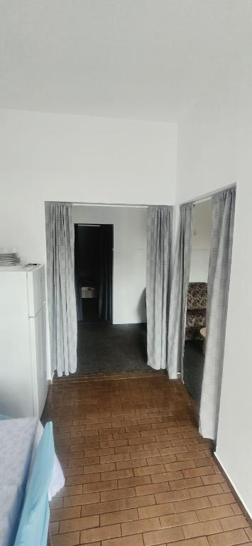 a room with a tunnel with curtains and a tile floor at D&ATurism in Prăjila