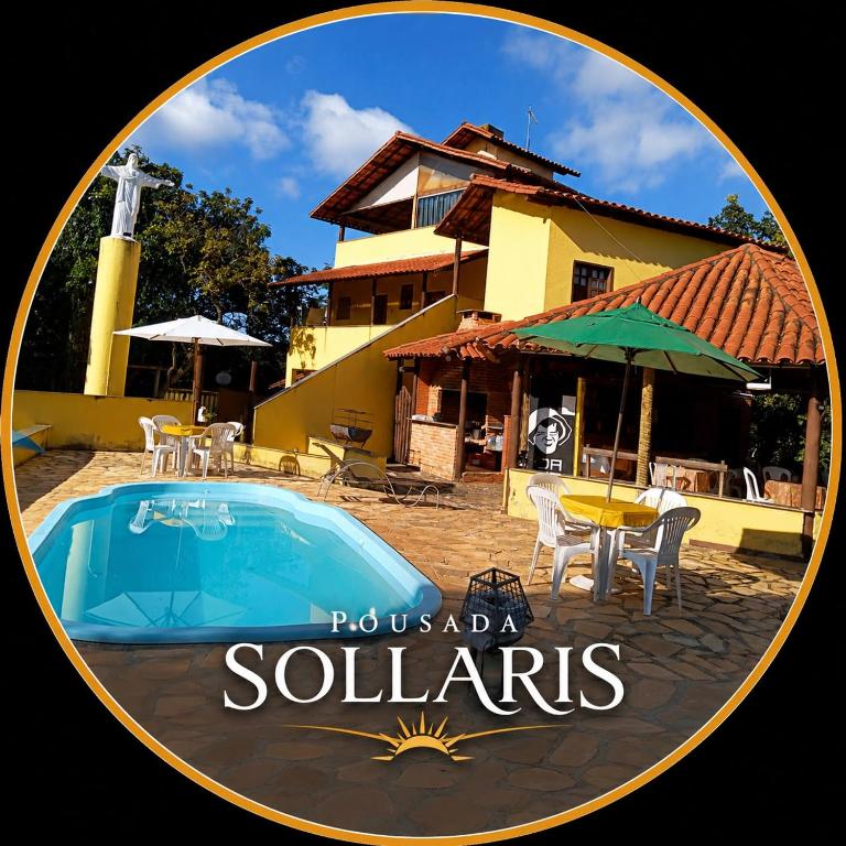 a picture of a pool in front of a house at Pousada sollaris in Serra do Cipo