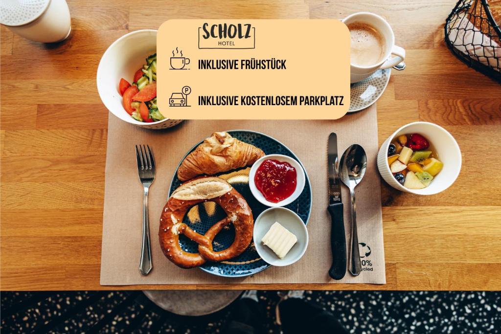 a tray of food with a plate of pretzels and a cup of coffee at Hotel Scholz in Aalen