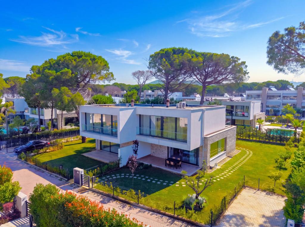 an aerial view of a white house with a garden at Azure Garden Villa 317 in Lalzit Bay