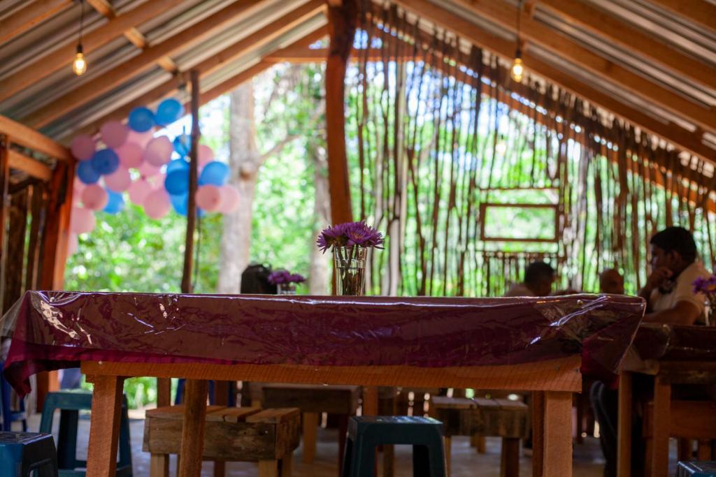 a table with a purple tarp on top of it at Down Fattna Eco Villa in Deniyaya