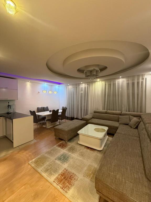 a living room with a couch and a table at Duplex in Kosovo Polje