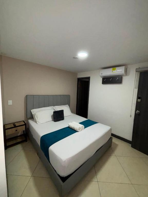 a bedroom with a large bed in a room at Hotel Casa Florida 70 Medellin in Medellín
