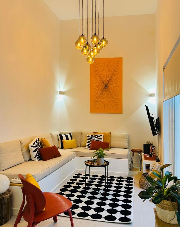 a living room with a couch and a table at Casa Longa Faro Entire House - Plunge Pool and Terrace in Faro