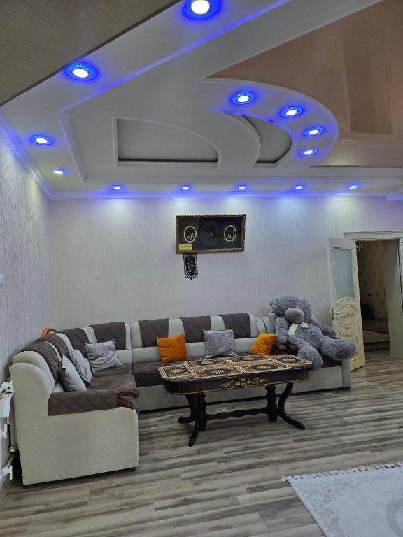 a living room with a couch and a table at Hamroz apartment in Navoi