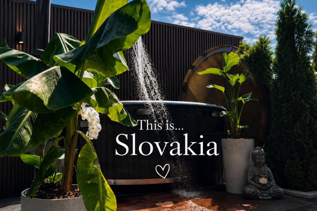 a sign that says this issloweka in front of a fountain at Vila GARUFA Wellness & Spa in Vysoké Tatry