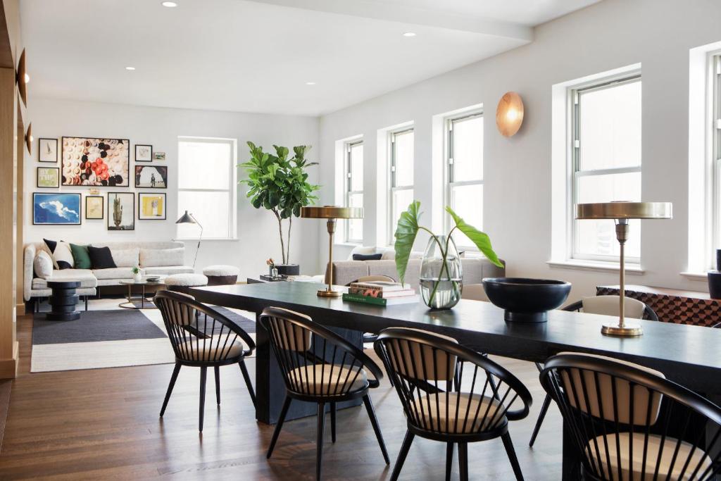 a living room with a dining room table and chairs at Kimpton - Harper Hotel by IHG in Fort Worth