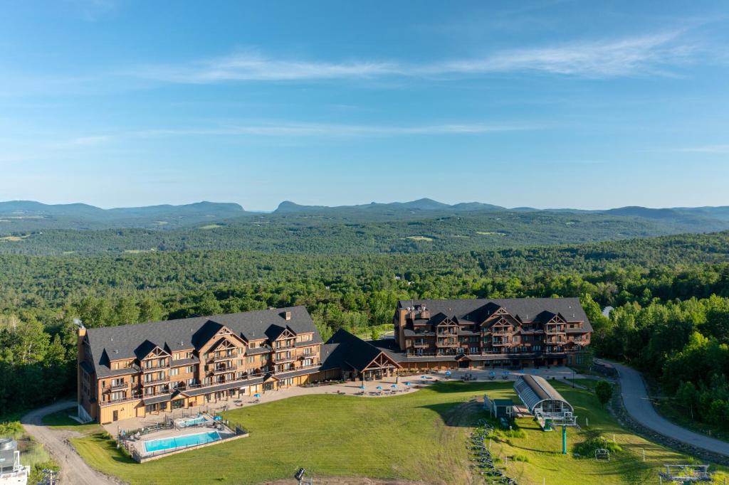 an aerial view of a large house with a pool at Burke Mountain Hotel in East Burke