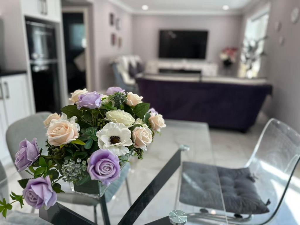 a vase of flowers sitting on a glass table at Amazing Garden view unit in Toronto