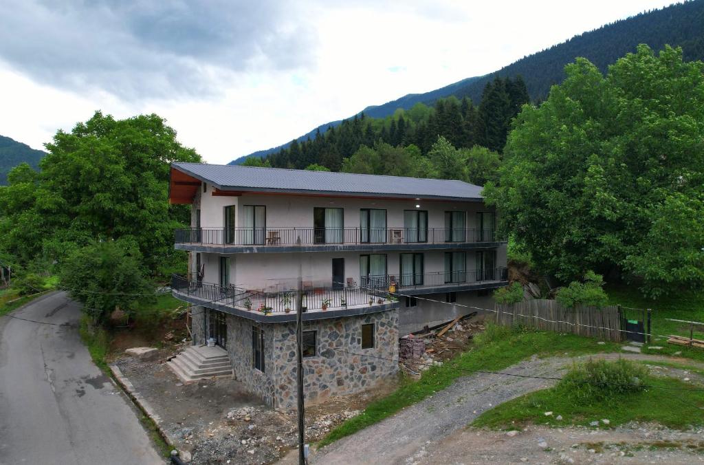 a house in the middle of a road at Lalveri INN in Mestia
