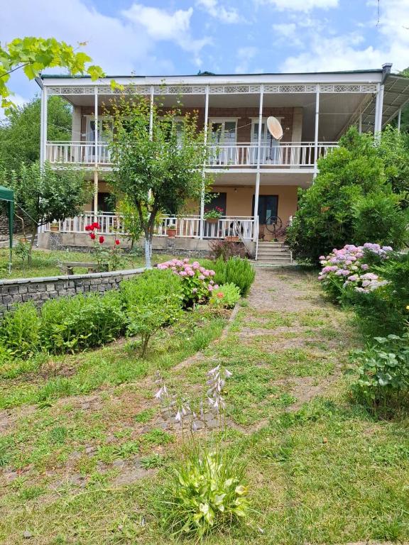 a house with a garden in front of it at Villa Borjomi in Akhaldaba