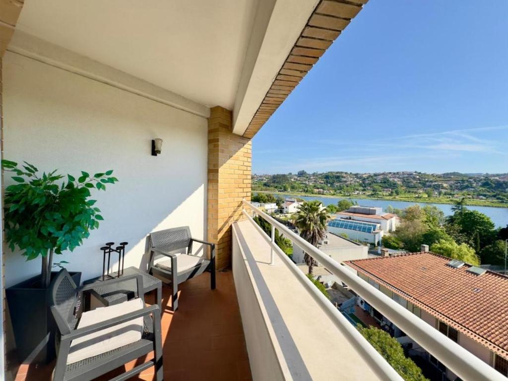 a balcony with chairs and a view of the water at Douro View by Porto in Valbom