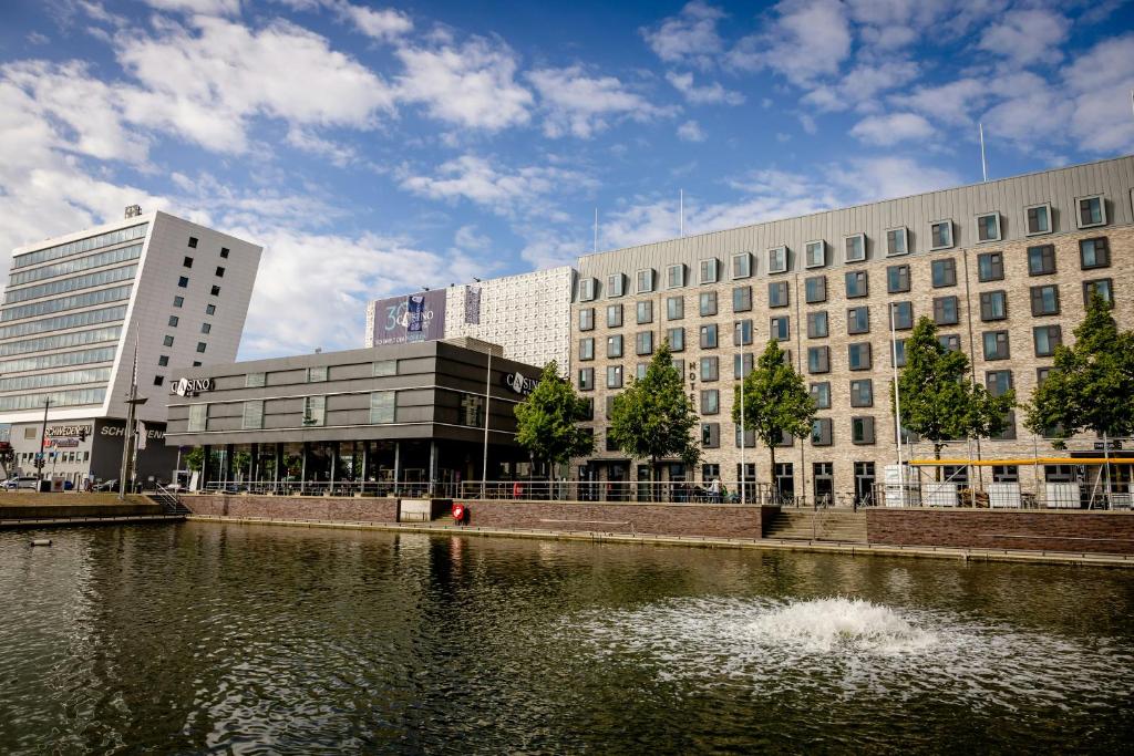 a city with buildings and a river with buildings at Hotel Kiel-Schwedenkai in Kiel