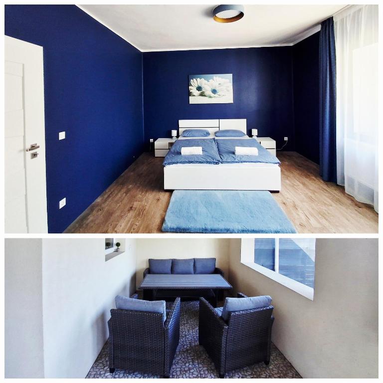 a bedroom with blue walls and a bed and chairs at SZEDERMÁLNA Vendégház in Sárospatak
