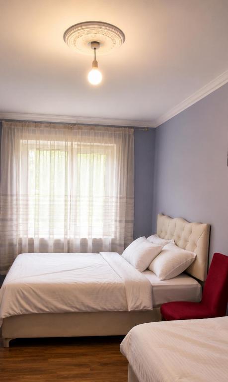 a bedroom with two beds and a window at Elasia in Martvili