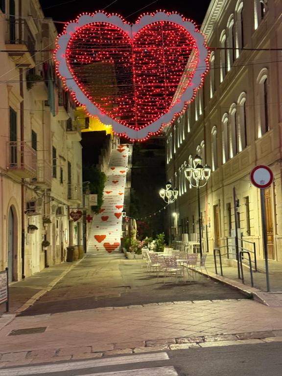 a city street with two hearts hanging from buildings at Maja cuore blu in Vieste