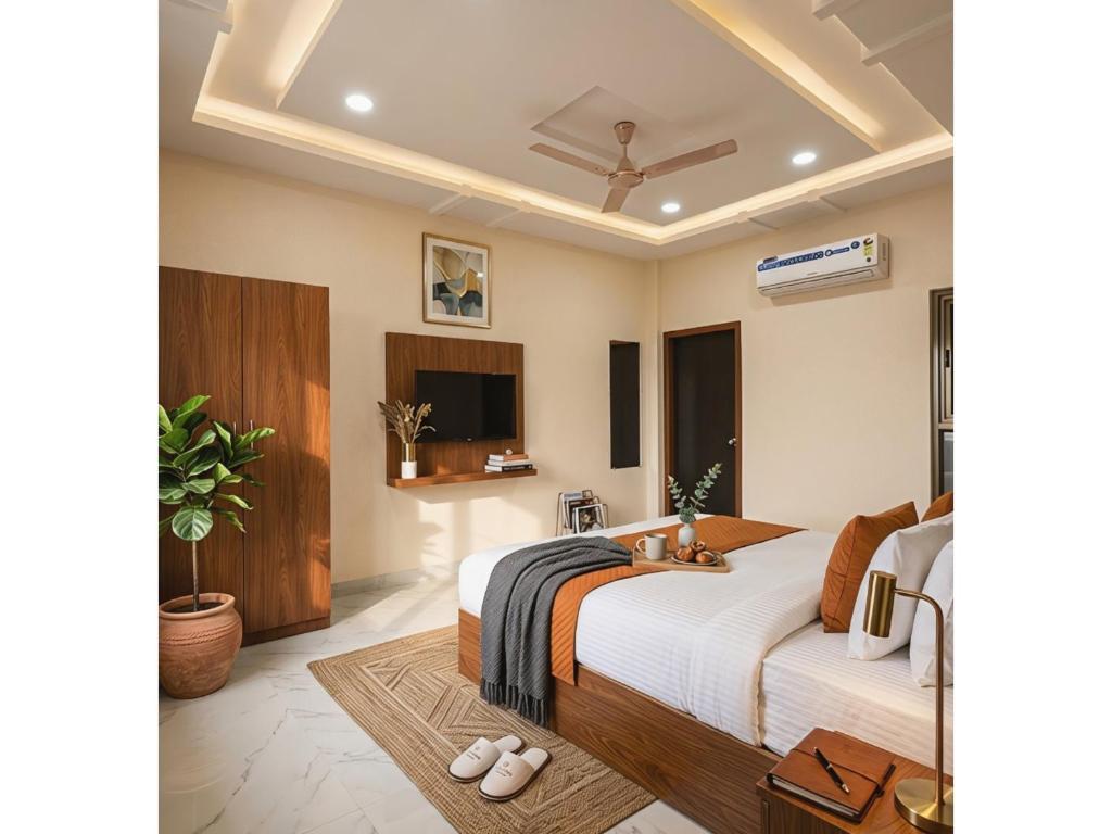 a bedroom with a large bed and a tv at Hotel Prime Access Inn in Indore