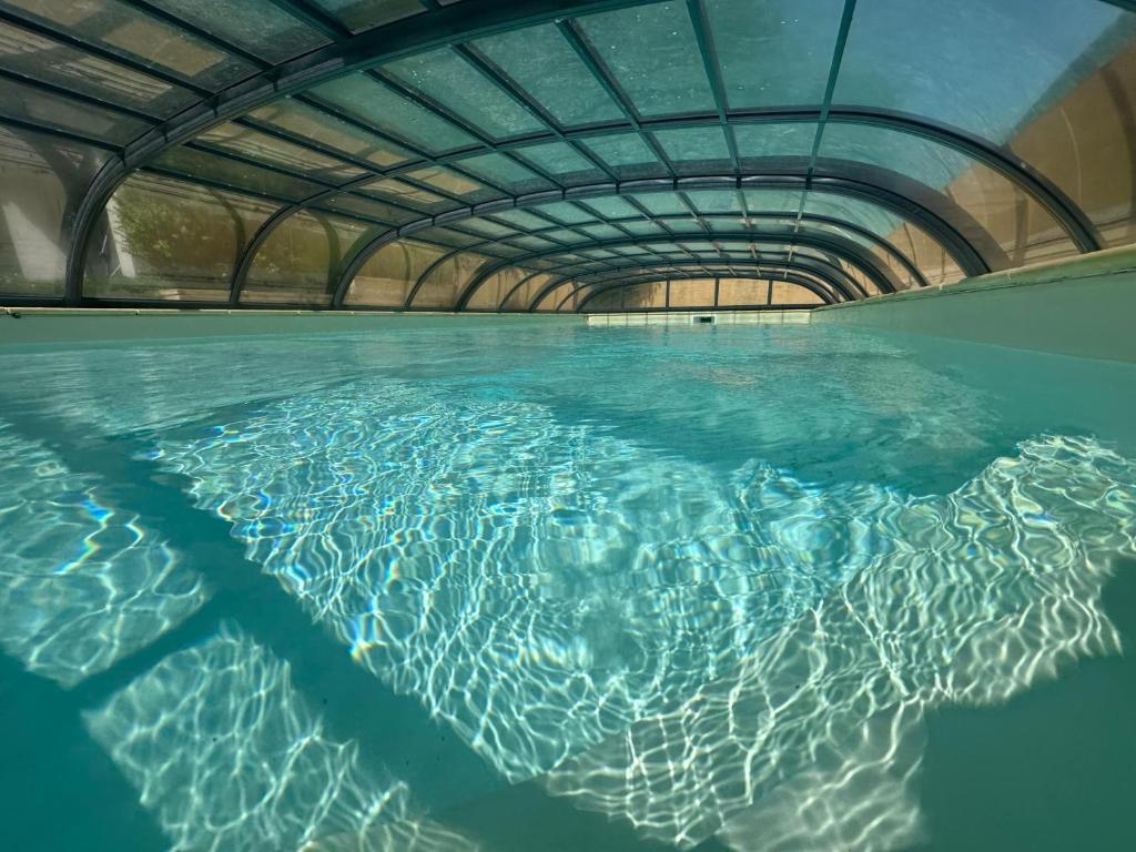 a pool of water with a tunnel in it at penty Broceliande 3 personnes in Guilliers