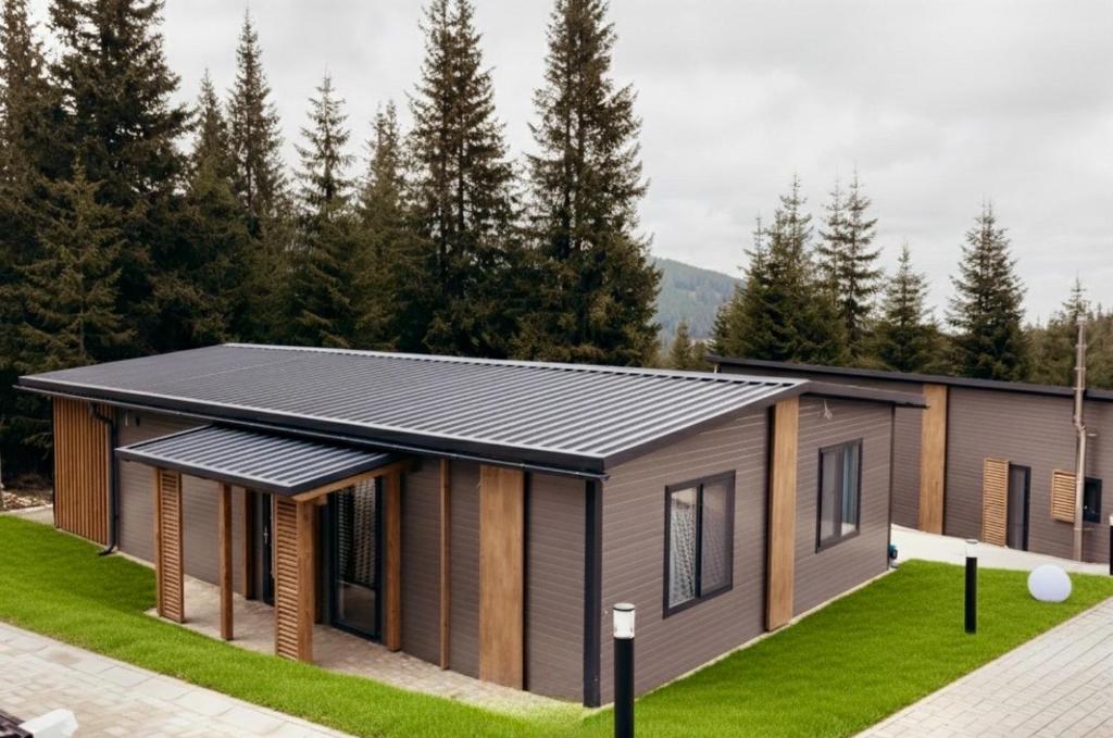 a modular home with solar panels on it at Nivalis Resort and SPA in Muntele Băişorii