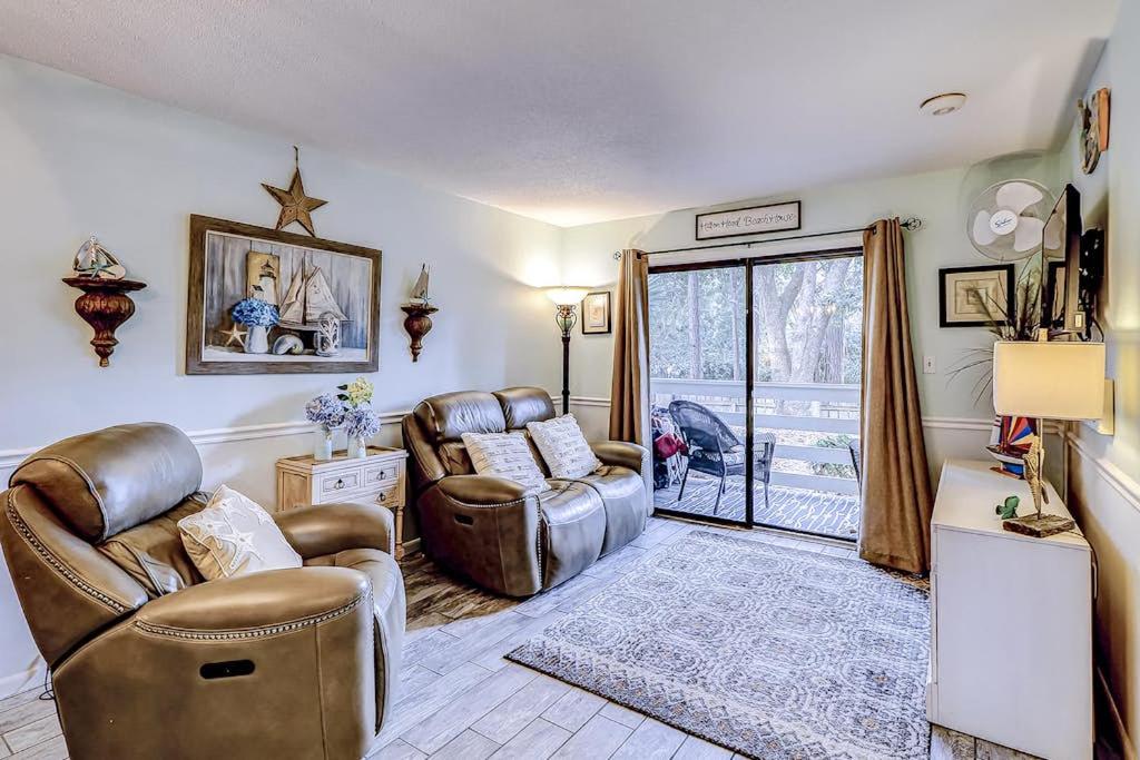 a living room with two chairs and a couch at Fiddlers Cove 18B in Hilton Head Island