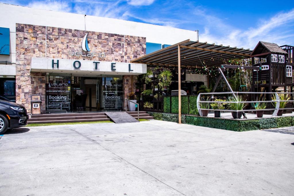 a hotel building with a car parked in front of it at Hotel Velario in Tijuana