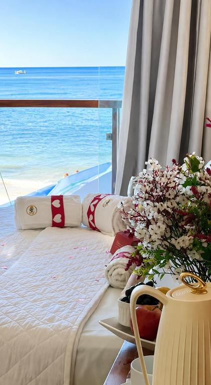 a bedroom with a bed with a view of the ocean at Pousada Manhã Dourada in Morro de São Paulo