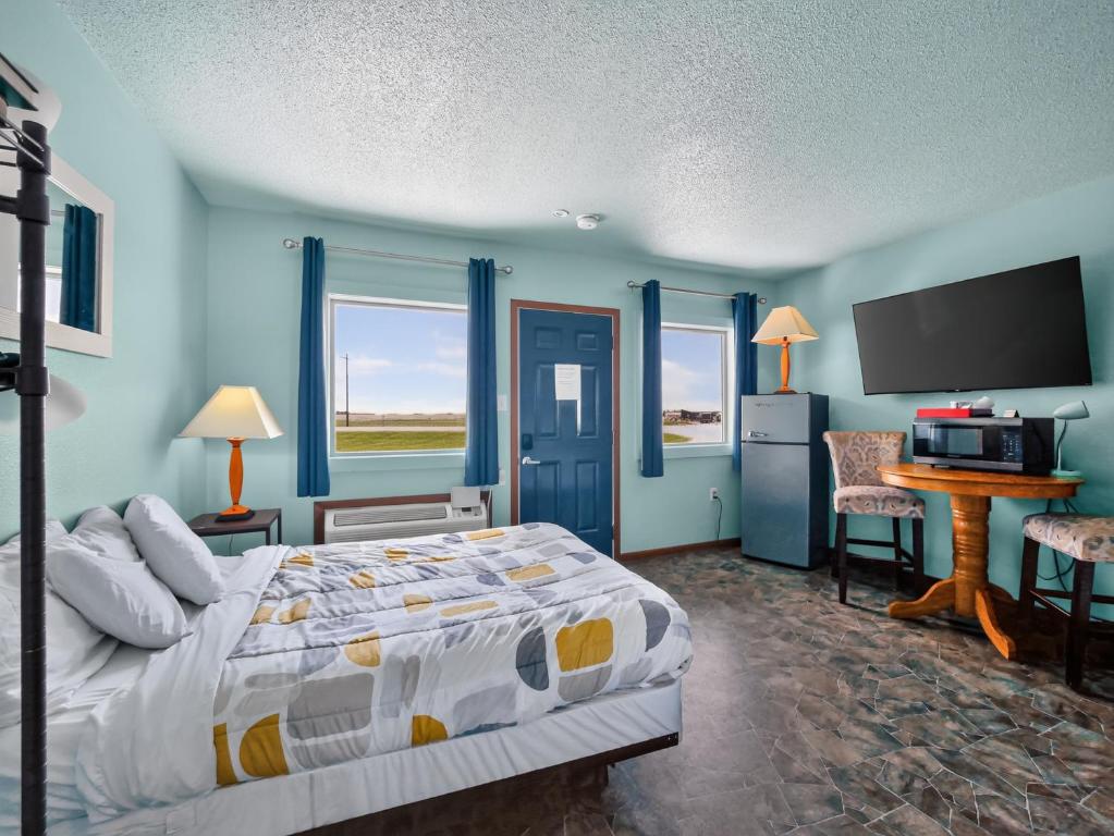a bedroom with a bed and a flat screen tv at Clara City Inn in Clara City