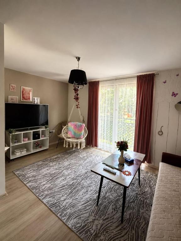 a living room with a couch and a table at Apartman Bambi Vlašić in Vlasic