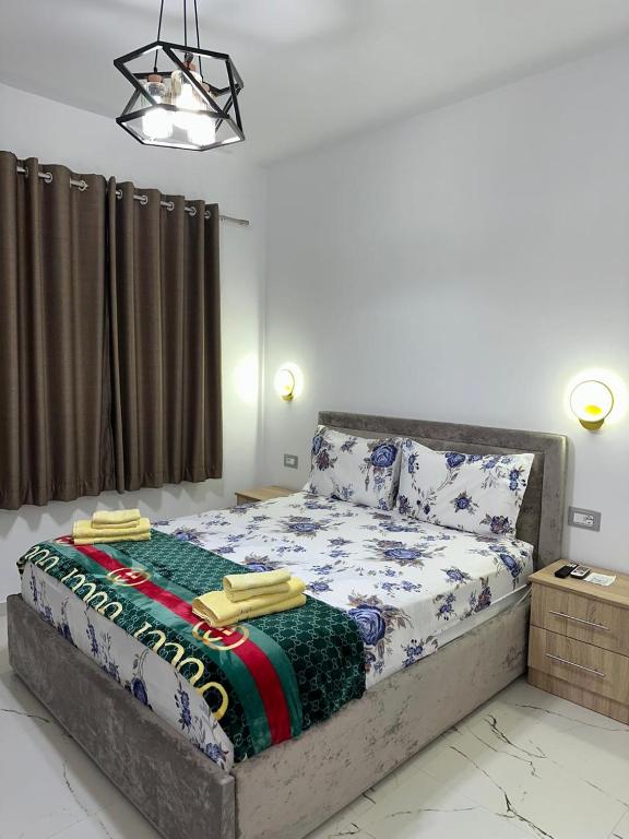 a bedroom with a bed with a blanket on it at Bujtina4A Rrenc in Renc