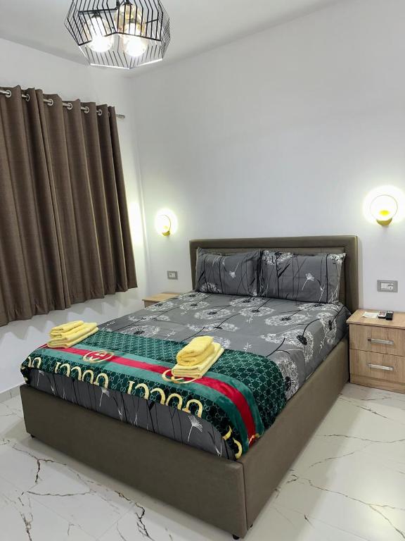 a large bed in a room with avertisementatronatronstrationstrationstrationstrationstration at Bujtina4A Rrenc in Renc