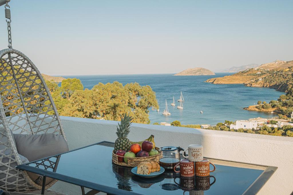 a table with a basket of fruit on a balcony at Monopetra View 2 Leros in Nisís Léros