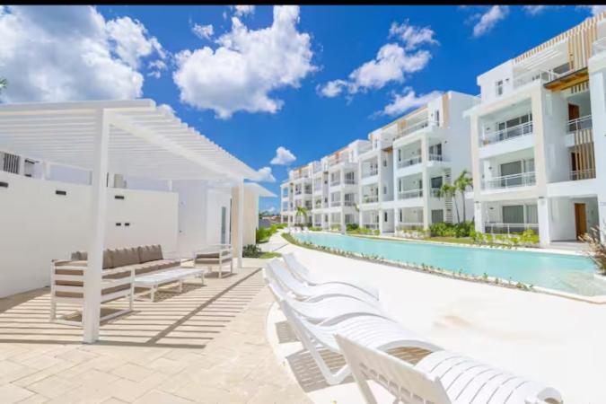 a resort with a swimming pool and white buildings at Bora 102 Garden Breeze 1 in La Laguna