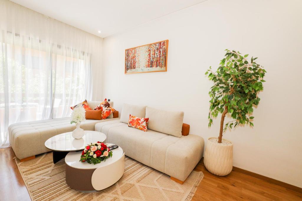 a living room with a couch and a potted plant at Hotel Targa 42 in Marrakesh