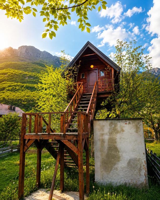 a tree house with a staircase leading up to it at TreeHouse Experience in Vusanje