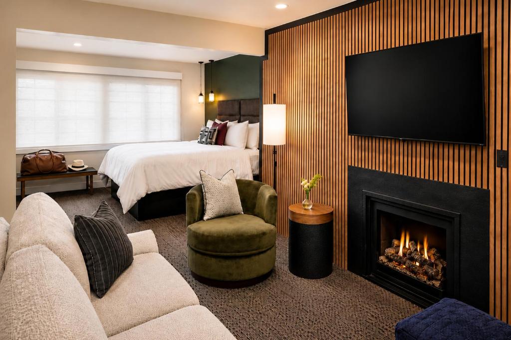 a hotel room with a fireplace and a bed at Wayside Inn in Carmel