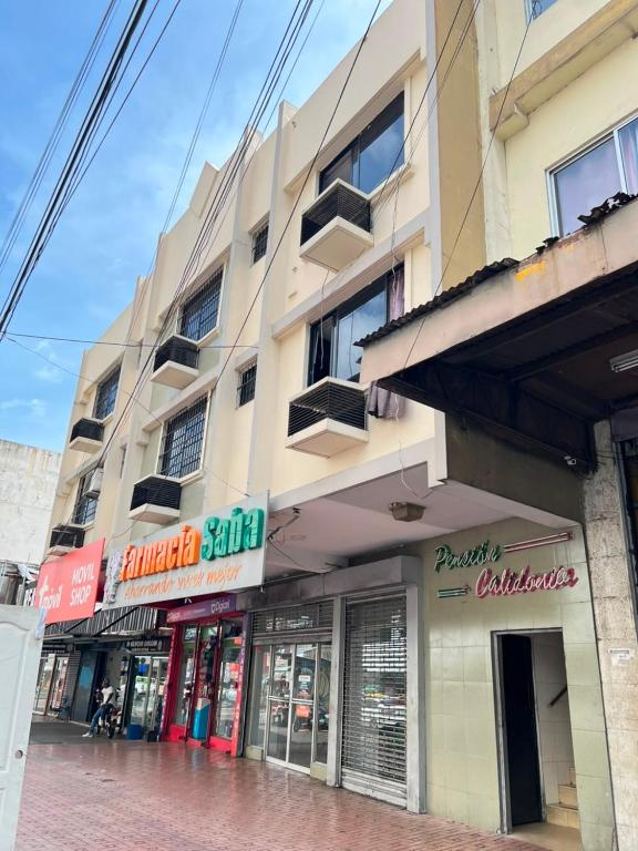 a building on a city street with shops at Pension Calidonia in Panama City