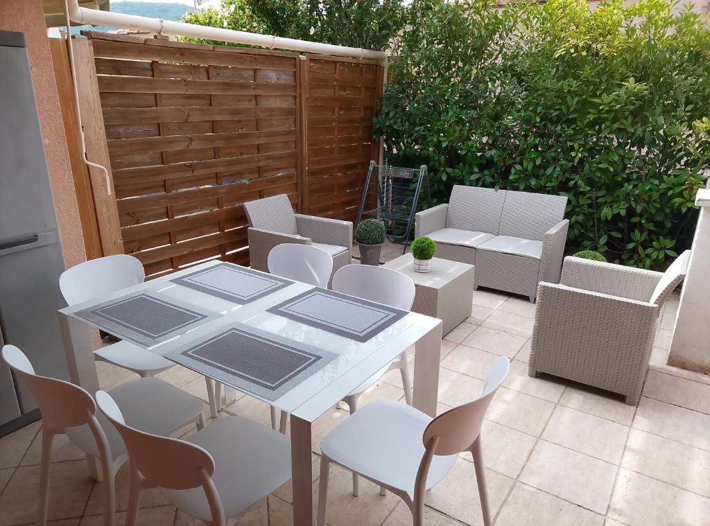 a white table and chairs on a patio at Mazet du bonheur in Saint-Martin-de-Brômes