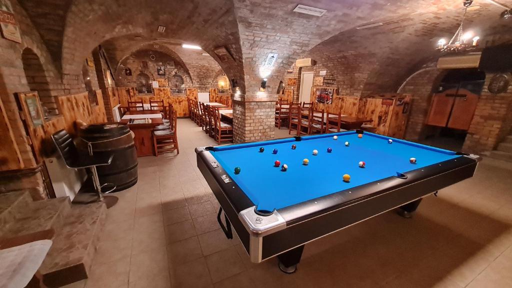 a pool table in a room in a cave at Pitvar Vendégház in Zalaegerszeg