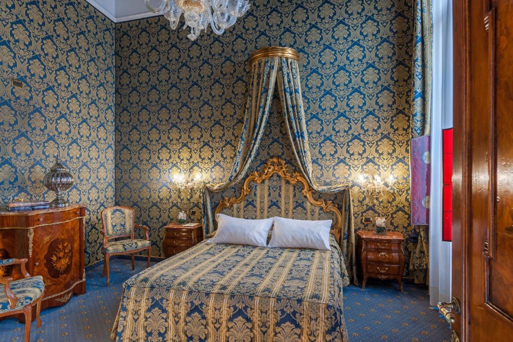 a bedroom with a bed with a canopy at Al Ponte Antico in Venice