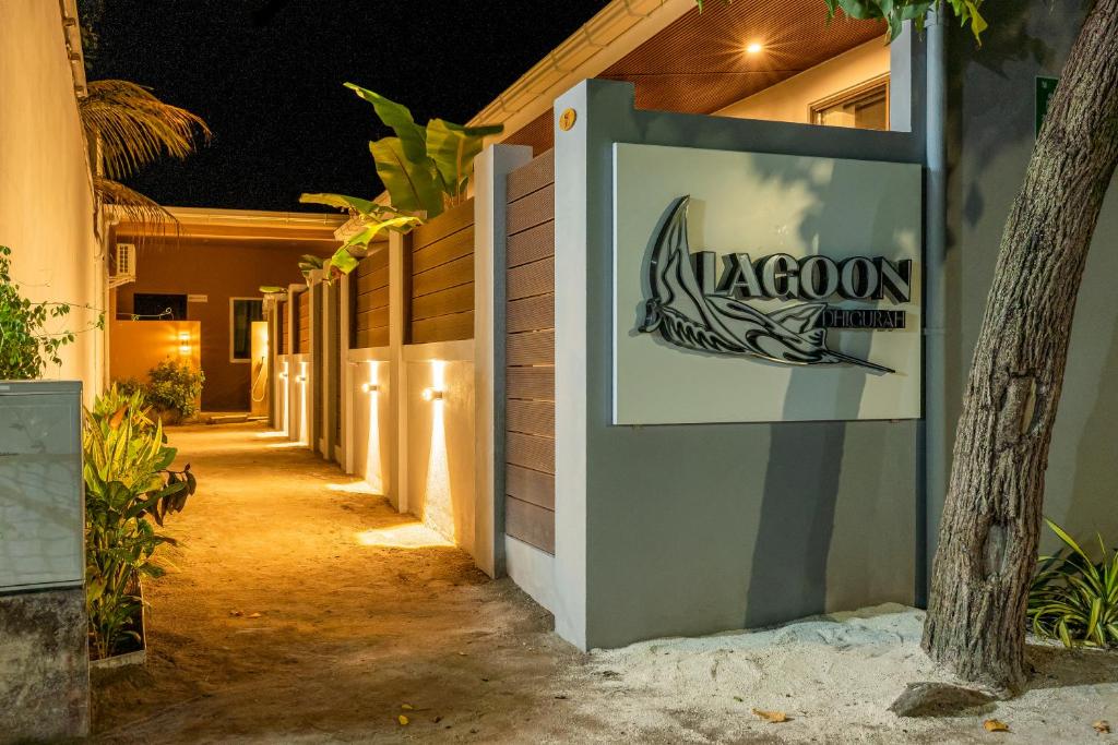 a sign for the lagoon resort at night at Lagoon Dhigurah in Dhigurah
