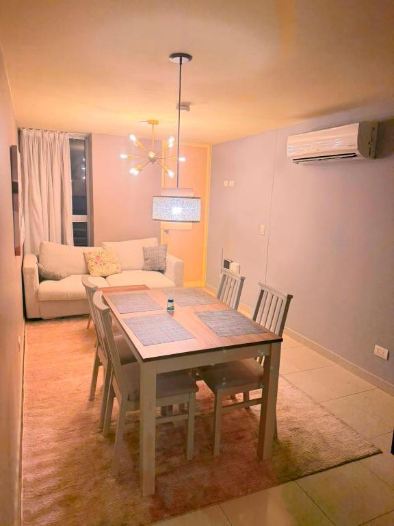 a living room with a table and chairs and a couch at Apto Amoblado Luxury in Bucaramanga
