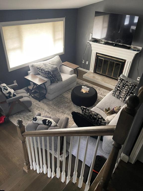 a living room with a couch and a fireplace at Queeneby in Brockton