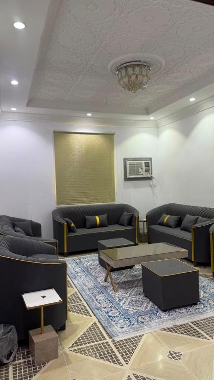 a living room with couches and a projection screen at اجنحة رحال لشقق الفروشة in Medina