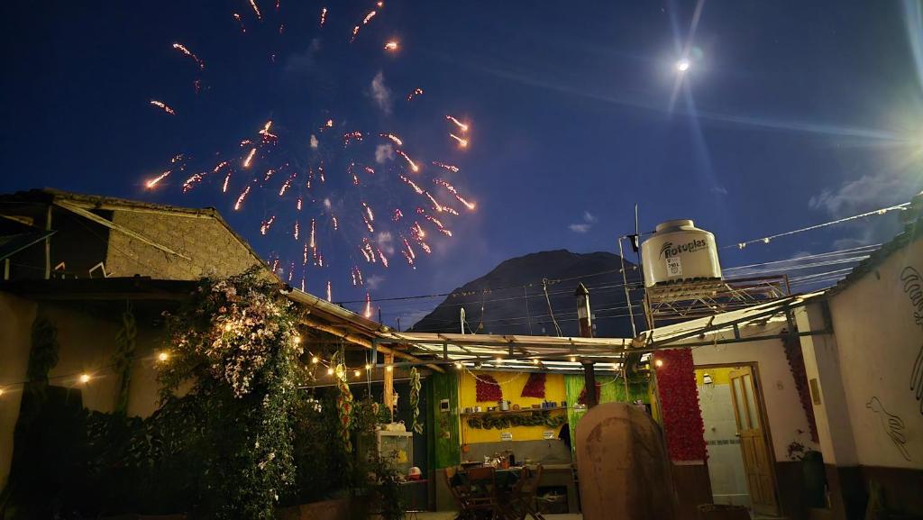 a fireworks display in the sky over a building at Moon Garden House in Pisac