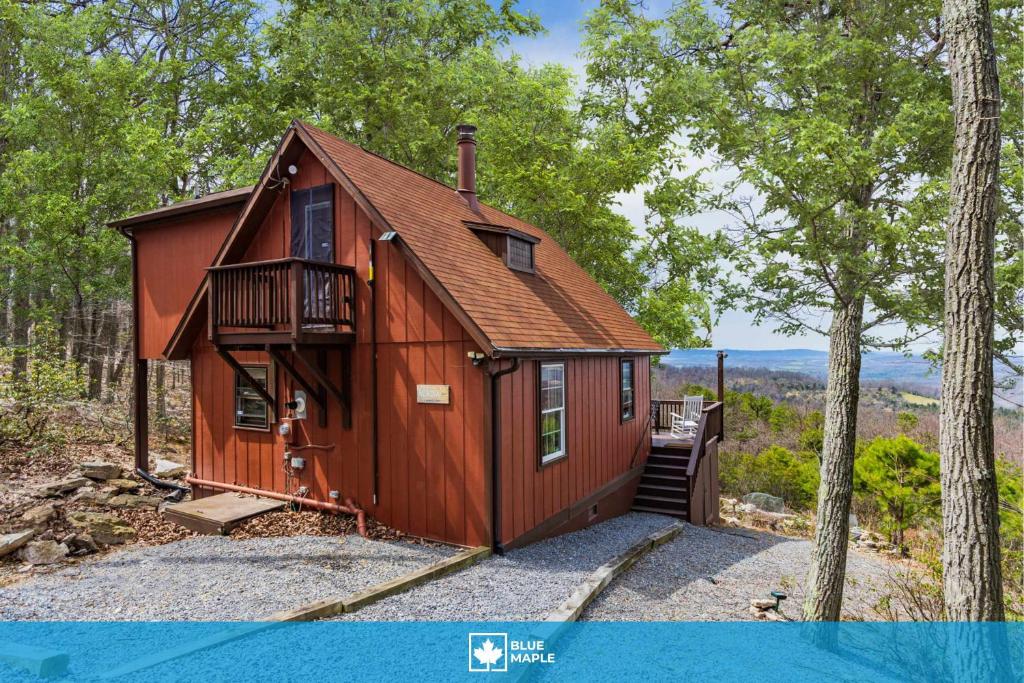 a tiny house in the woods with a balcony at Mountain chalet w hot tub & private balcony in Augusta