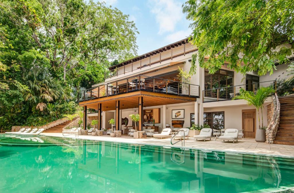 an exterior view of a house with a swimming pool at Las Lagunas Boutique Hotel in Flores