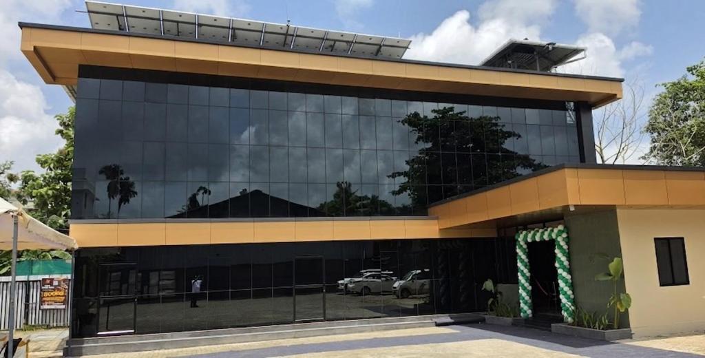 a large glass building with a lot of windows at Hotel Grand Illam in Ernakulam